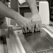 Solder paste being applied through silk screen onto LED light engine